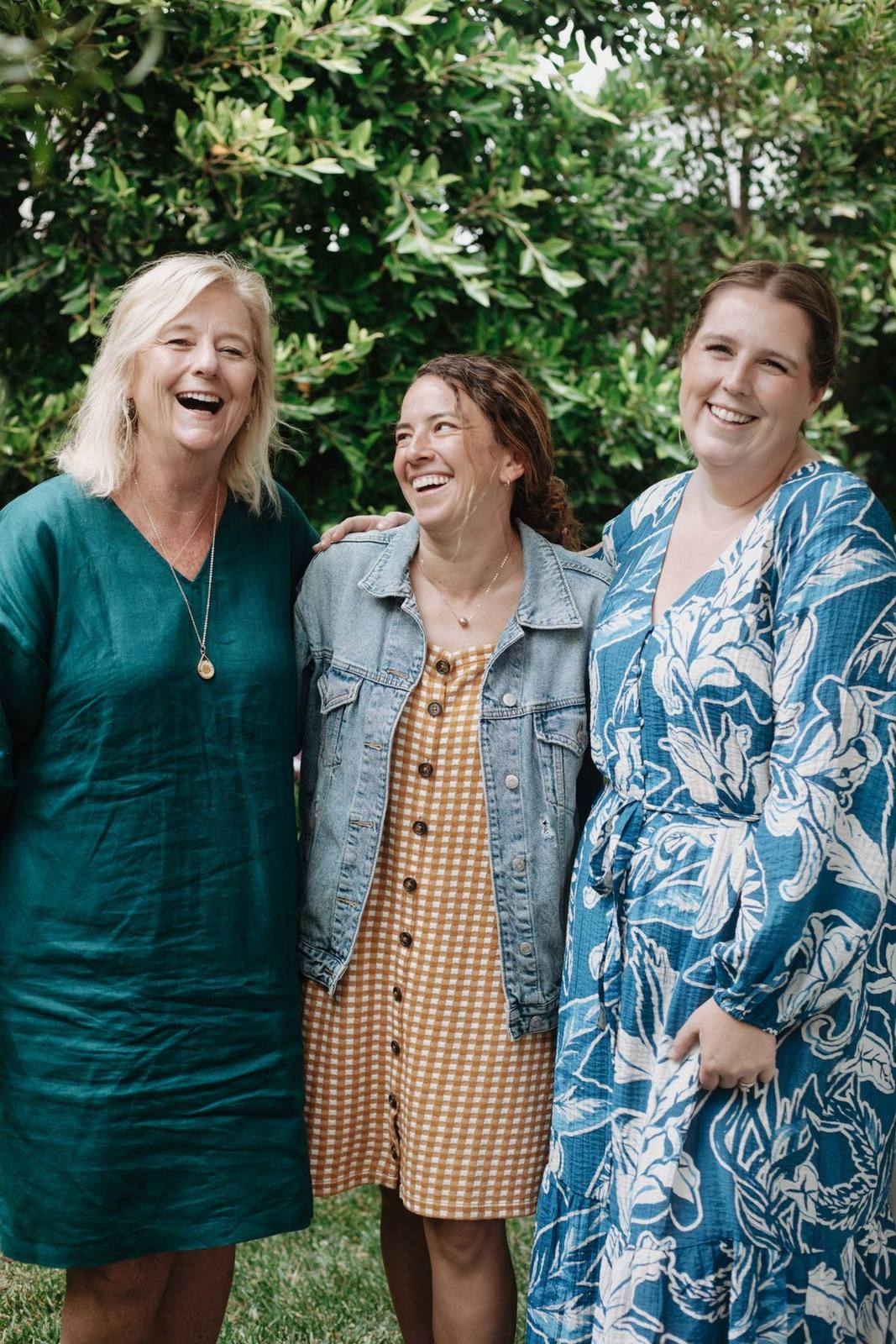 Dr. Bergstrom laughing with two colleagues in her garden